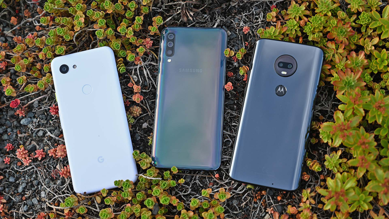 The Galaxy A50 side-by-side against its biggest competitors: the Pixel 3a (left) and the Moto G7 (right).